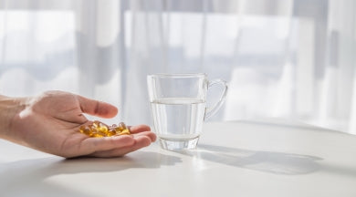 Rejuva Capsules(Ingredients, Benefits)- Women with a glass of water and capsule in hand